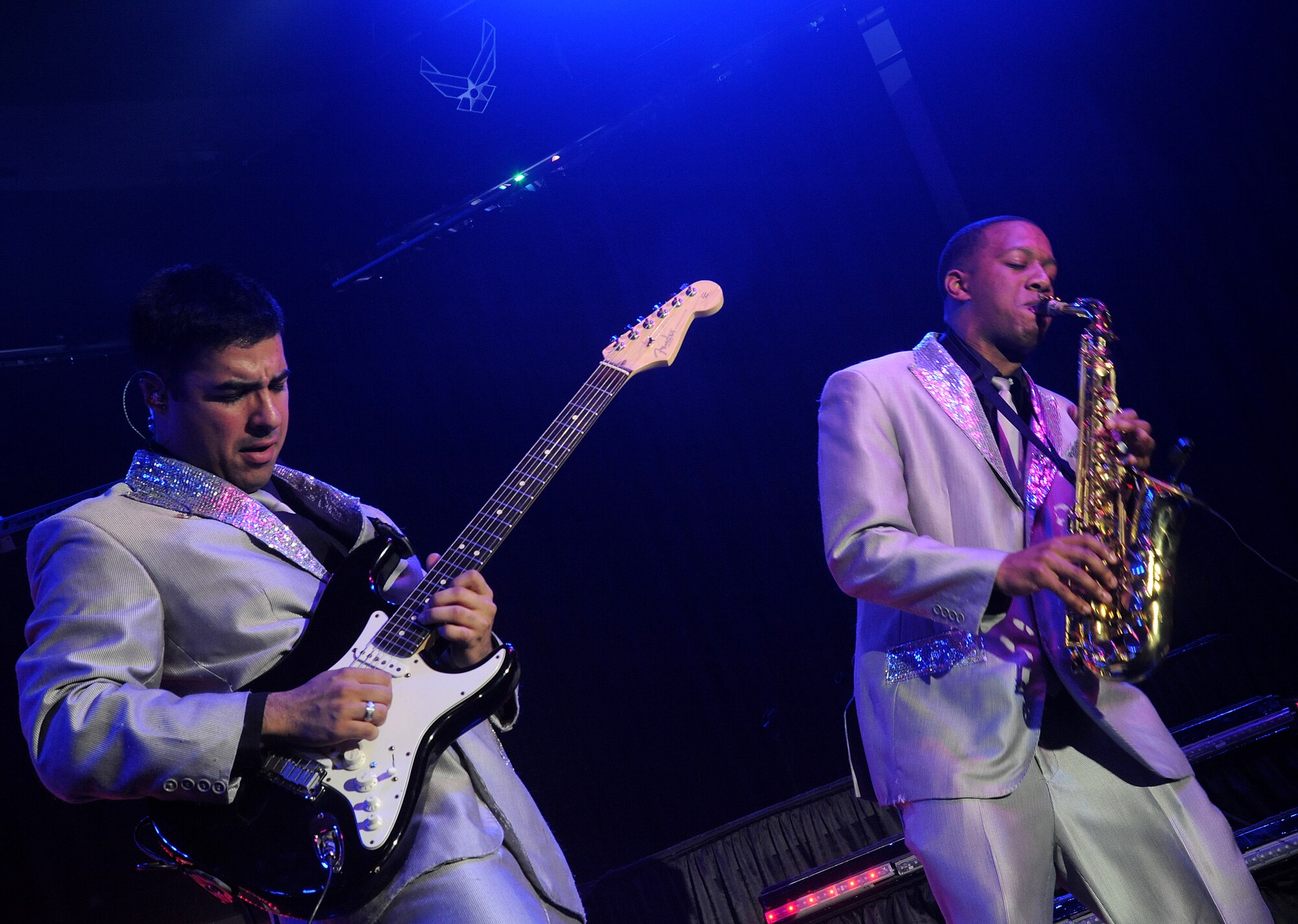 Senior Airman Kenneth Del Valle Ruiz, Tops in Blue electric guitar (left) has an instrumental battle during a Tops in Blue performance  with Airman 1st Class Wynton Warren, Tops in Blue alto saxophone (right), at the Keystone Theater on Kadena Air Base, Japan, Nov. 16, 2012. This year’s Tops in Blue performance entitled “Listen” is being performed for service members throughout the United States as well as 20 countries worldwide. (U.S. Air Force photo/Staff Sgt. Laszlo Babocsi