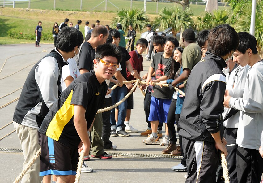 U.S. service members and local Okinawan community members twist ropes together for the International Tug-of-War in Okinawa City, Japan, Nov. 18, 2012. Once the volunteers create the individual ropes, they are wrapped around other ropes to create a giant rope that will be used Nov. 24 at the International Tug-of-War. (U.S. Air Force photo/Airman 1st Class Malia Jenkins)