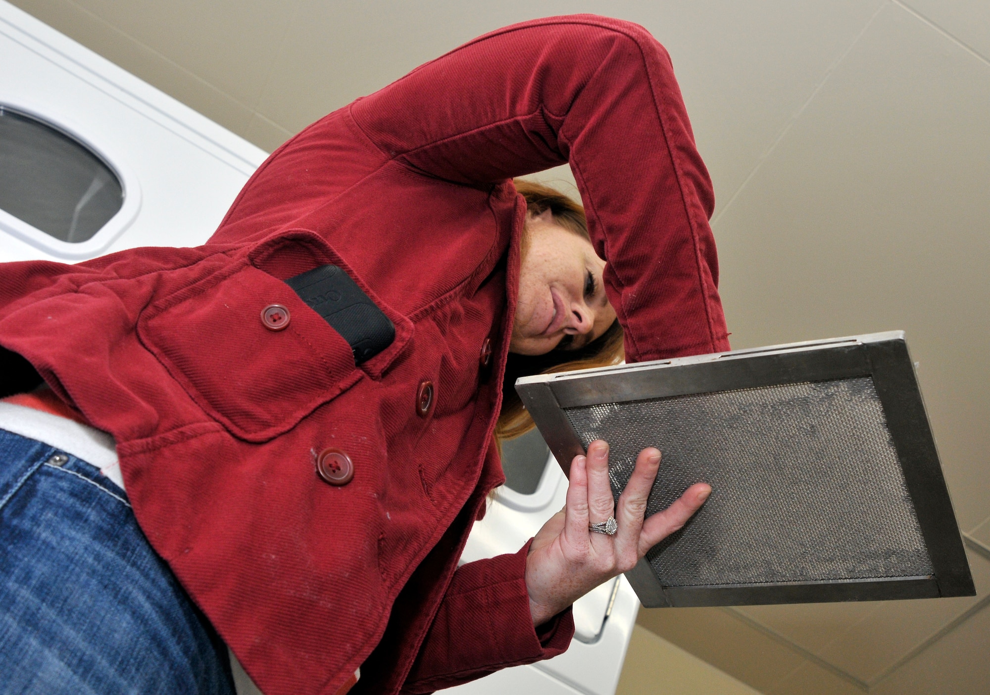 Kelly Sussman, 35th Civil Engineer Squadron volunteer, cleans a clogged lint filter during an energy usage inspection at Misawa Air Base, Japan, Nov. 15, 2012. Clogged lint filters make the dryer work harder and break, which means going to the Laundromat for dry clothes. Clogged filters also pose a fire hazard. (U.S. Air Force photo by Tech. Sgt. Phillip Butterfield)