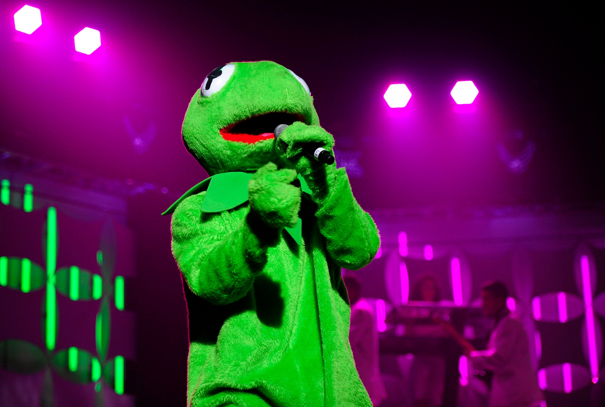 A Tops In Blue vocalist dressed as Kermit the Frog sings in a duet for the Misawa Air Base community and Japanese citizens, Nov. 14, 2012, at the Misawa City Civic Center, Japan. Tops in Blue visited Misawa as part of their 2012 world tour, which provides music, song and dance to audiences in more than 85 locations. (U.S. Air Force photo by Staff Sgt. Jess Lockoski)