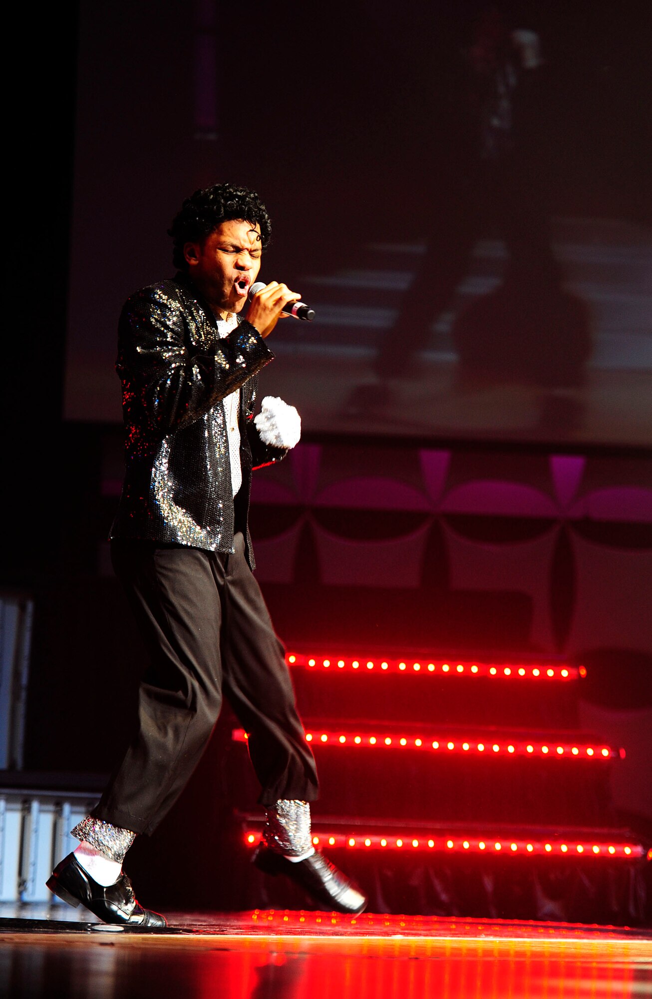 U.S. Air Force Staff Sgt. Tyron Jones, Tops In Blue vocalist, sings a song by famous pop artist, Michael Jackson, Nov. 14, 2012, at the Misawa City Civic Center, Japan. For nearly 60 years, Tops in Blue, the Air Force’s premiere entertainment showcase, has provided the military community and public with world-wide performances. (U.S. Air Force photo by Staff Sgt. Jess Lockoski)