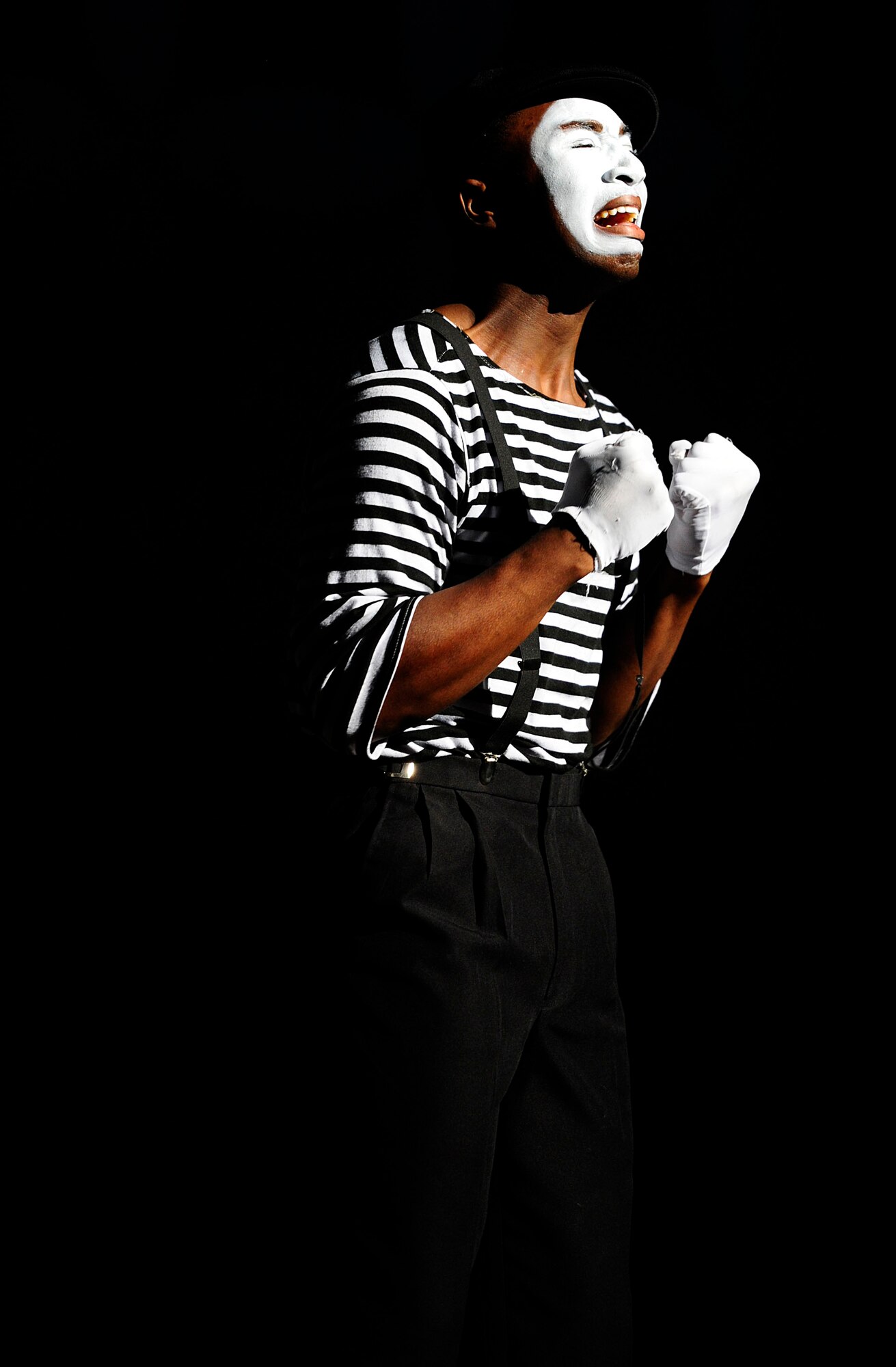 U.S. Air Force Senior Airman Charles Cooper, Tops In Blue vocalist, expresses a mime performance to the song, Grenade, by artist Bruno Mars, Nov. 14, 2012, at the Misawa City Civic Center, Japan. Tops In Blue, the Air Force’s premiere entertainment showcase comprised of more than 35 Airmen, provided entertainment for more than 800 Misawa Air Base residents and Japanese citizens. (U.S. Air Force photo by Staff Sgt. Jess Lockoski)