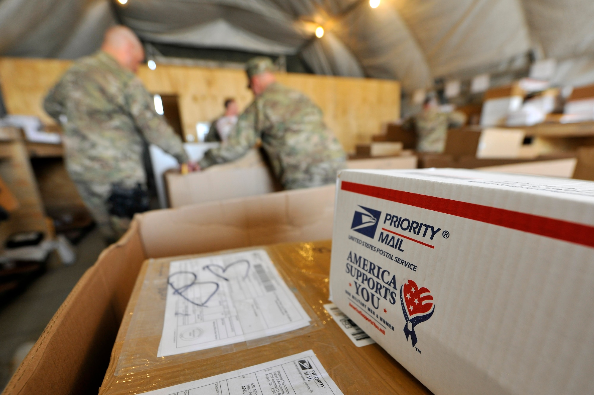 Airmen of the 455th Expeditionary Knowledge Operations Management office sort boxes and envelopes for personnel at Bagram Airfield, Afghanistan, Nov. 15, 2012.  Members of the KOM office dedicate themselves, day-in and day-out, to provide an appreciated service to 455th Air Expeditionary Wing by keeping the mail flowing. (U.S. Air Force photo/Senior Airman Chris Willis)