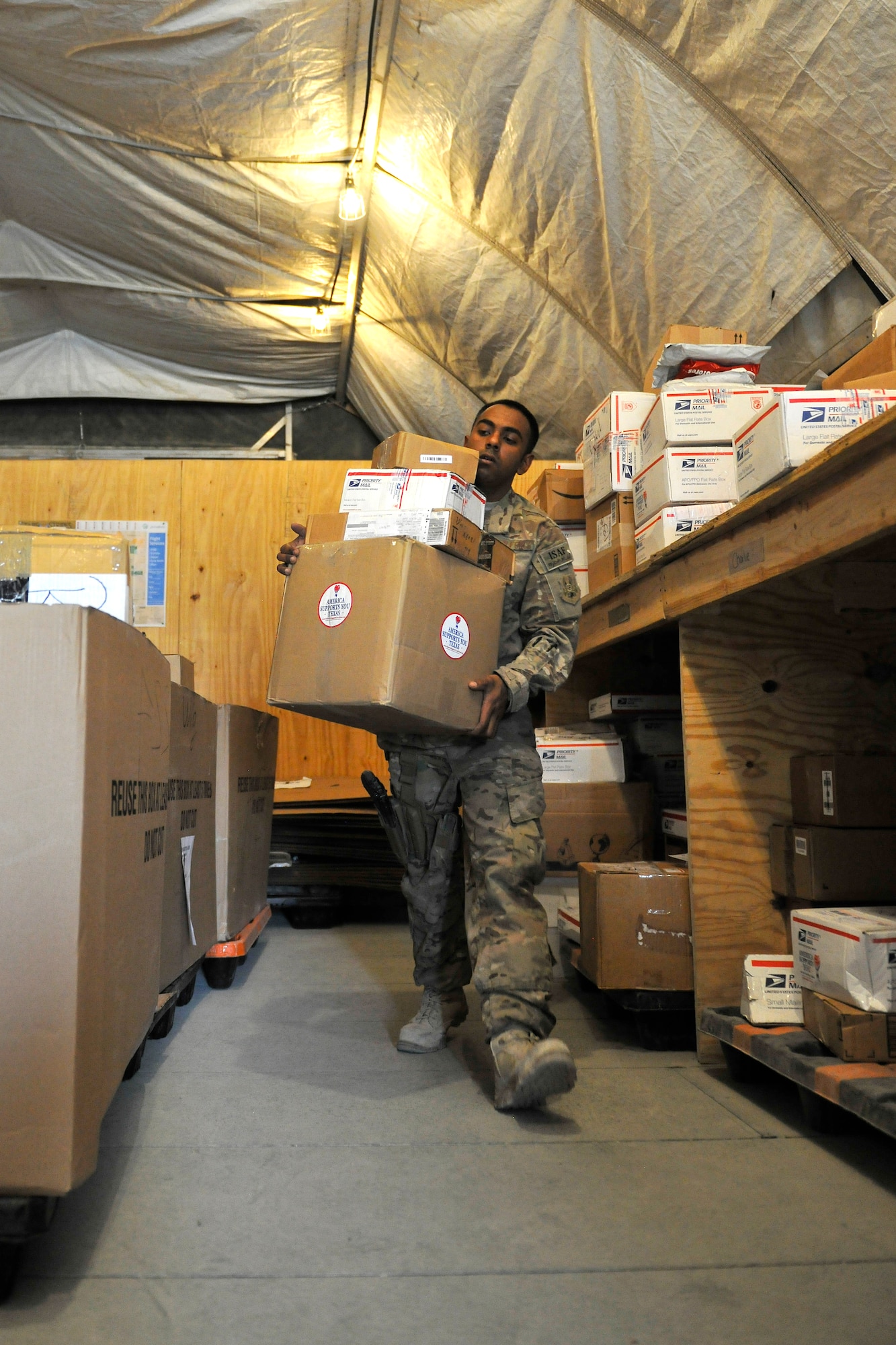 Senior Airman Krishan Narain, a member of the 455th Expeditionary Knowledge Operations Management office, sorts mail for the entire wing at Bagram Airfield, Afghanistan, Nov. 15, 2012.  The KOM Office handles the sorting and delivery of the base mail, as well as other functions like managing the Automated Military Postal System with accountable mail notifications. (U.S. Air Force photo/Senior Airman Chris Willis)