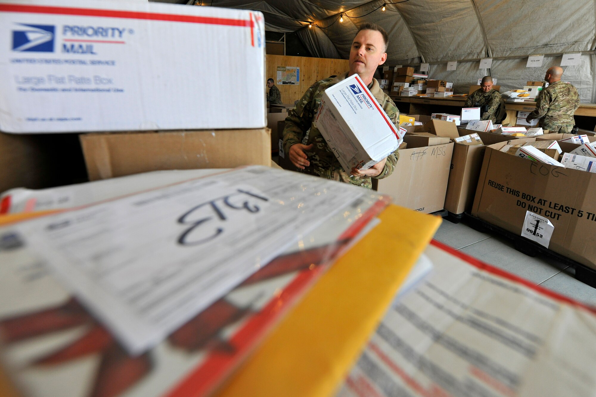 Tech. Sgt. Shawn McCowan, a member of the 455th Air Expeditionary Wing Public Affairs, volunteers to sort mail at the postal annex at Bagram Airfield, Afghanistan, Nov. 15, 2012.  Many Airmen from different units volunteer during the holiday season when the in-coming mail nearly doubles for BAF personnel.  (U.S. Air Force photo/Senior Airman Chris Willis)