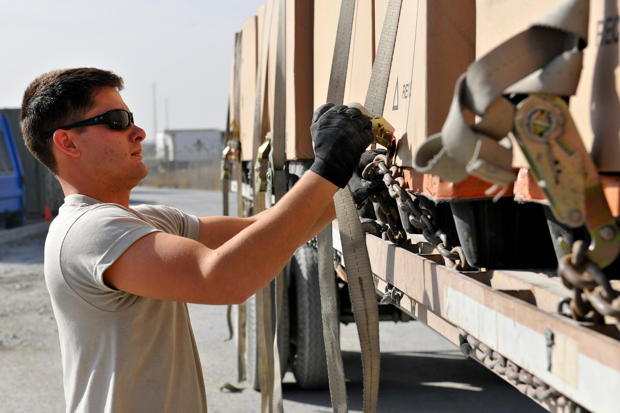 Staff Sgt. Nicholas Evans, a member of the 455th Expeditionary Logistics Readiness Squadron, unloads 24 containers of mail from a flatbed truck at Bagram Airfield, Afghanistan, Nov. 15, 2012.  BAF Airmen receive an average of 18 containers of mail per day and more than 35 containers during the holiday season. (U.S. Air Force photo/Senior Airman Chris Willis)