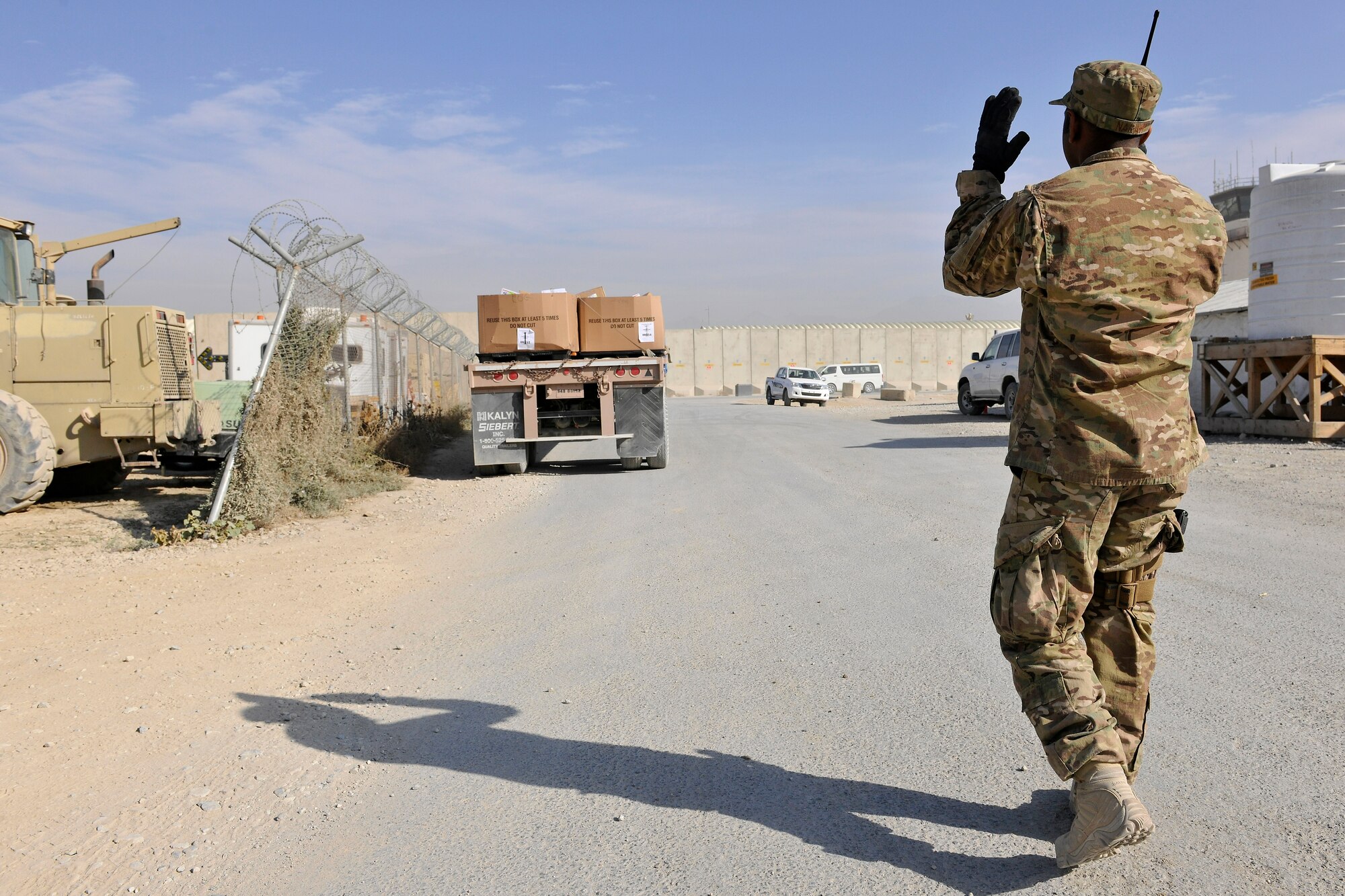 Senior Airman Krishan Narain, a member of the 455th Expeditionary Knowledge Operations Management office, guides a flatbed truck loaded with 24 pallets full of mail at Bagram Airfield, Afghanistan, Nov. 15, 2012.  More than 180,000 pounds of mail are sent to BAF personnel per month but averages will reach nearly 300,000 pounds during the holiday season. (U.S. Air Force photo/Senior Airman Chris Willis)