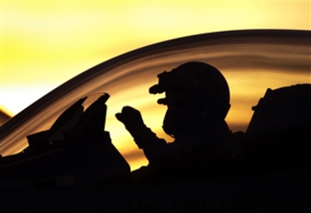 A U.S. Air Force F-16 Fighting Falcon pilot uses hand signals to communicate with the ground crew as he prepares to take off for a night mission during exercise Green Flag-West 13-02 at Nellis Air Force Base, Nev., on Nov. 1, 2012.  The pilot is assigned to the 187th Fighter Wing, Alabama Air National Guard.  