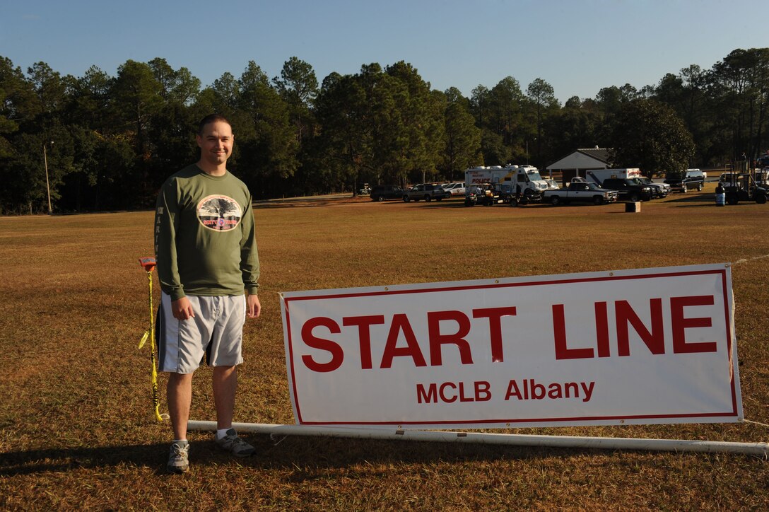 Capt. Kyle Thomas, deputy Public Affairs Officer, Marine Corps Logistics Base Albany, poses at the starting line before beginning the Dirty Devil Dog Mud Run at MCLB Albany, Nov. 17.