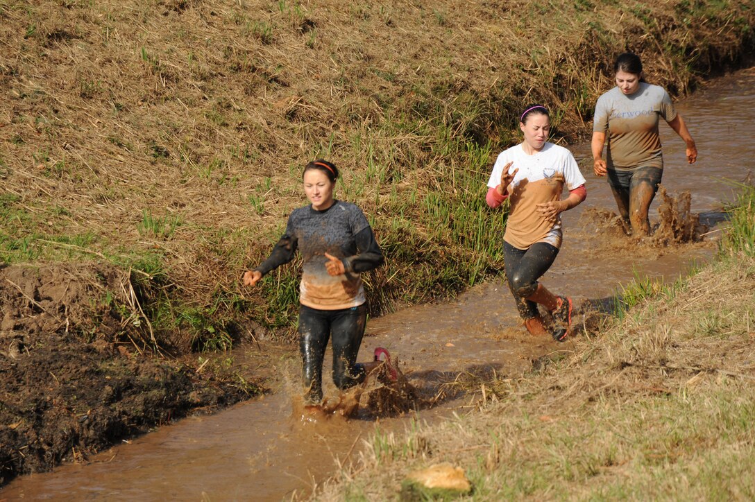 Runners slog through the mud in a canal during Marine Corps Logistics Base Albany's Dirty Devil Dog Mud Run, Nov. 17.