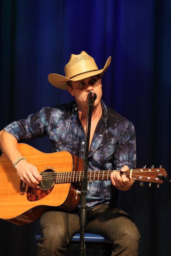 Dustin Lynch sings one of his hit singles as a part of the 4th Annual WRNS Guitar Pull concert at the Cherry Point theater Nov. 14. "I have gotten a lot of emails from men and women overseas who hear my song 'Cowboys and Angels,' and say it helps them get through their deployment," said Lynch. "I promised my pops that any chance I got to perform for these amazing men and women, I would. I would do these shows every day if I could." 