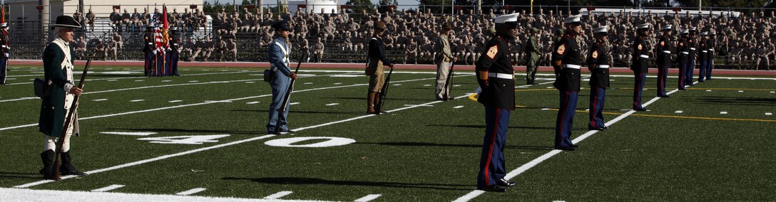 Marines dressed in authentic historical uniforms as well as Marines the Honor Guard stand for the cake cutting ceremony as part of the Joint Daytime Ceremony aboard Marine Corps Base Camp Lejeune Nov. 2. The ceremony shared Marine Corps traditions and honored combined efforts between the naval services. 