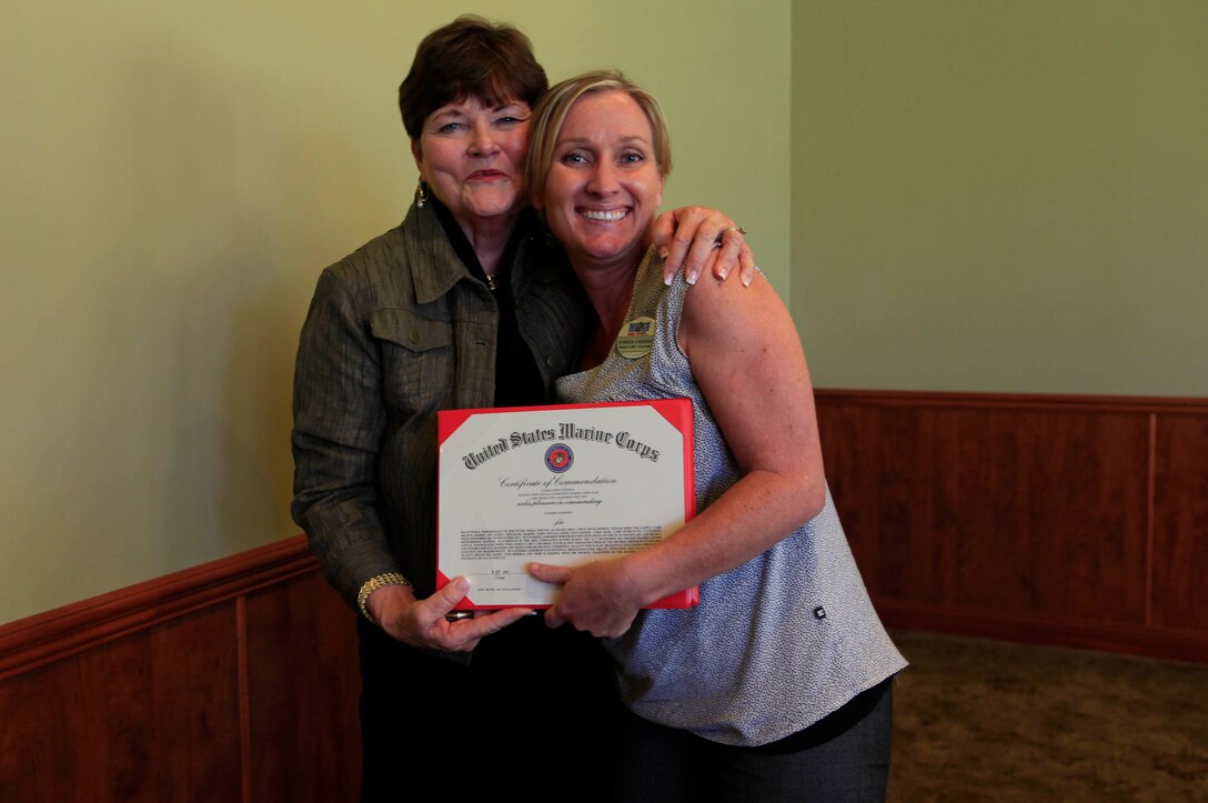 Summer Anderson, Stuart Mesa Child Development Center director, receives a certificate of appreciation for her contributions during this year’s unannounced child care center compliance inspection here Oct. 19. Headquarters Marine Corps inspected all areas of operations to ensure the programs and centers are providing the best possible care for service members and their families.