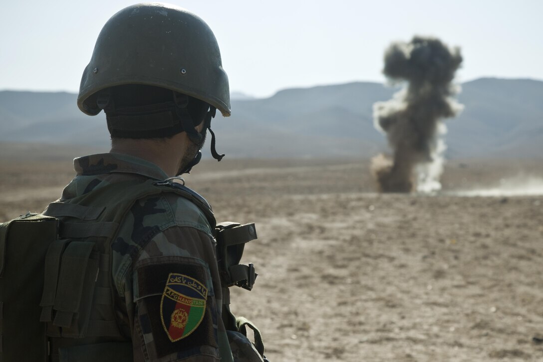 A commando with 9th Special Operations Kandak, Afghan National Army, watches a controlled detonation during counter improvised explosive device training with Marines from U.S. Marine Corps Forces, Special Operations Command in Herat province, Afghanistan, Nov. 12, 2012. Afghan National Security Forces have been taking the lead in security operations, with coalition forces as mentors, to bring security and stability to the people of the Islamic Republic of Afghanistan. (U.S. Marine Corps photo by Sgt. Pete Thibodeau/Released)