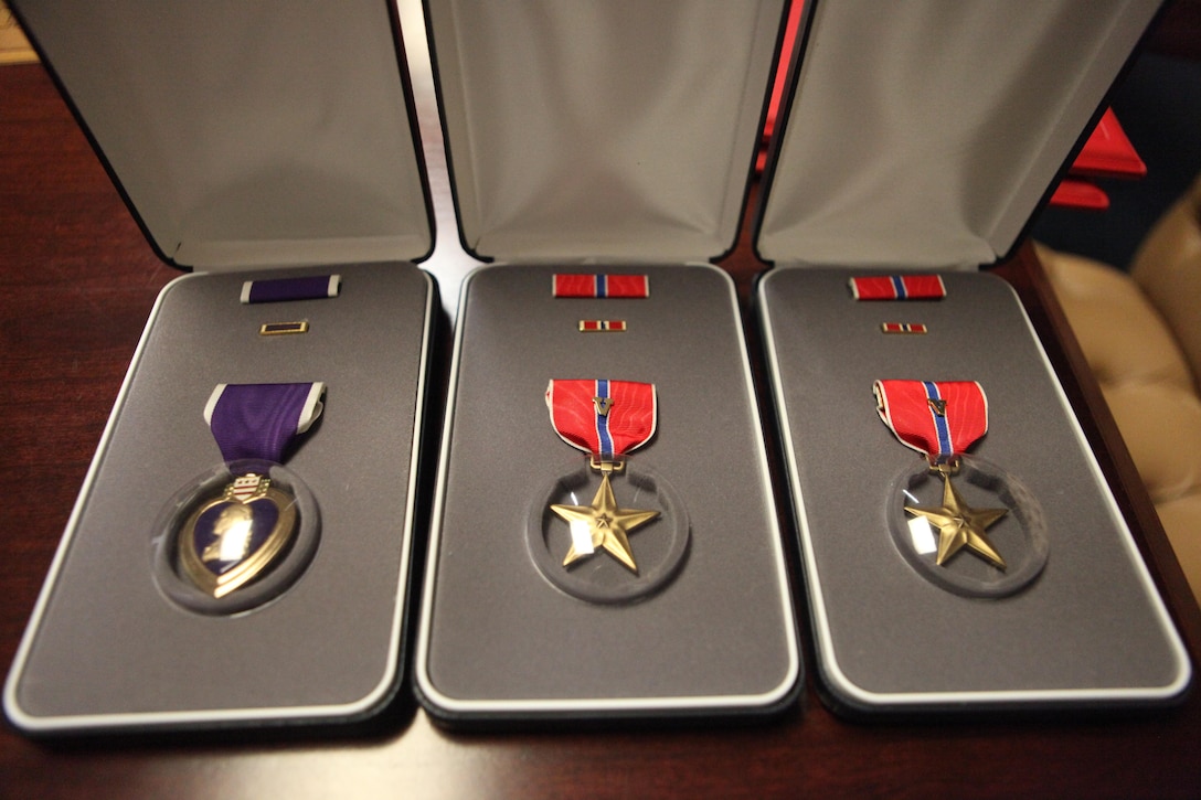 A Purple Heart and two Bronze Star medals are displayed at U.S. Marine Corps Forces, Special Operations Command headquarters before being awarded posthumously to the family of Gunnery Sgt. Jonathan W. Gifford aboard Camp Lejeune, NC Nov. 15. Gifford, who was killed in Afghanistan in July, was honored with two other fallen MARSOC Marines and a Sailor during a celebration of life ceremony, where friends, families and fellow servicemembers gathered to pay tribute to those who had paid the ultimate sacrifice. (U.S. Marine Corps photo by Sgt. Anthony Carter/Released)