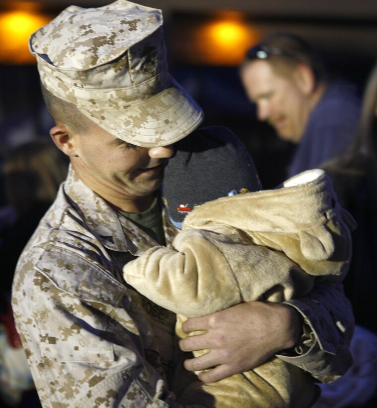 Lance Cpl. Jefferey Rose, a tank crewman from Company E, 4th Tank Battalion, 4th Marine Division, meets his four-month year old son for the first time Nov. 15, 2012, at Fort Knox, Ky., after returning from a six-month deployment to Afghanistan.  The Nebo, Ky., native said seeing his son made him the happiest he has ever been. (U.S. Marine Corps Photo by Cpl. Nana Dannsa-Appiah/Released)