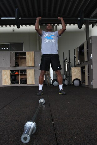 Seaman Tyler Wash, an 11th Dental Company lab technician and afternoon High Intensity Tactical Training participant, does thrusters at the HITT center at the IronWorks Gym here, Nov. 7, 2012. Thrusters are conducted to work out arms, back and legs simultaneously and were one of several exercises Wash did to better his endurance during the afternoon workout.