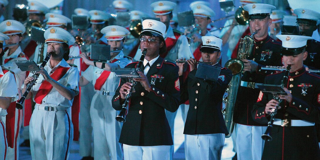 Marines of the III Marine Expeditionary Force Band play side by side with numerous bands from the Japan Self-Defense Force during the 2012 Japan Self-Defense Force Marching Festival at the Nippon Budokan Arena in Tokyo Nov. 17. Hours of practice were put into the festival by the Marines to ensure their performance with the other bands would go smoothly. 