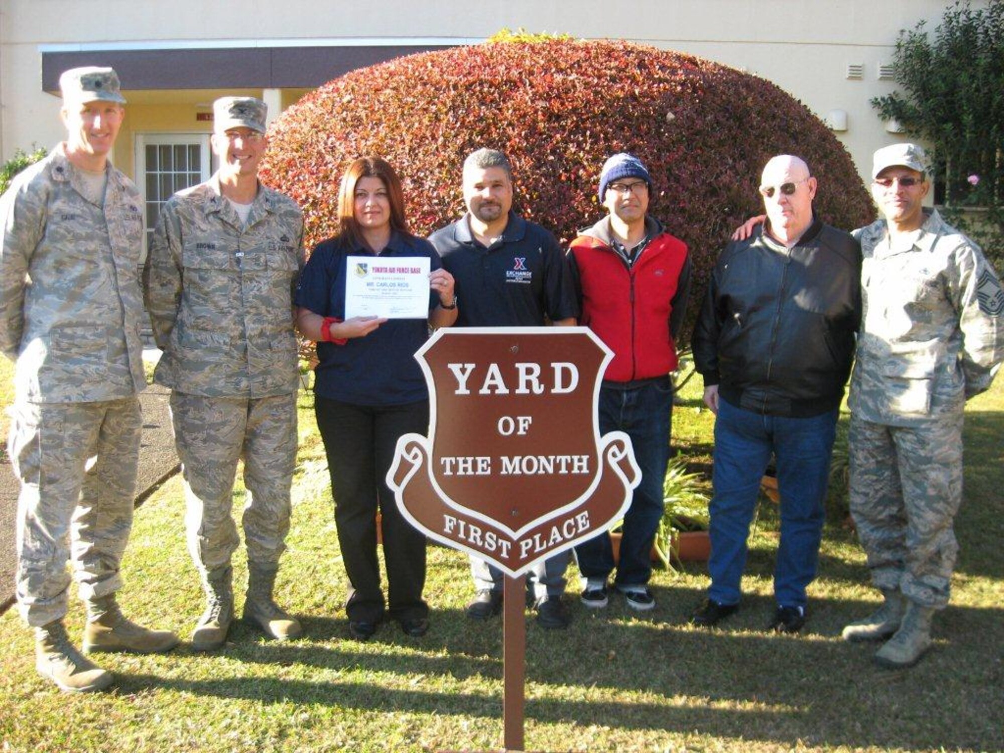 YOKOTA AIR BASE, Japan -- 374th Mission Support Group leadership stands with the 1st place winners of the new Yard of the Month program, Carlos Rios and Janet Vazquez, Army and Air Force Exchange Service employees, at Yokota Air Base, Japan. (Courtesy photo from the 374th Civil Engineer Squadron)