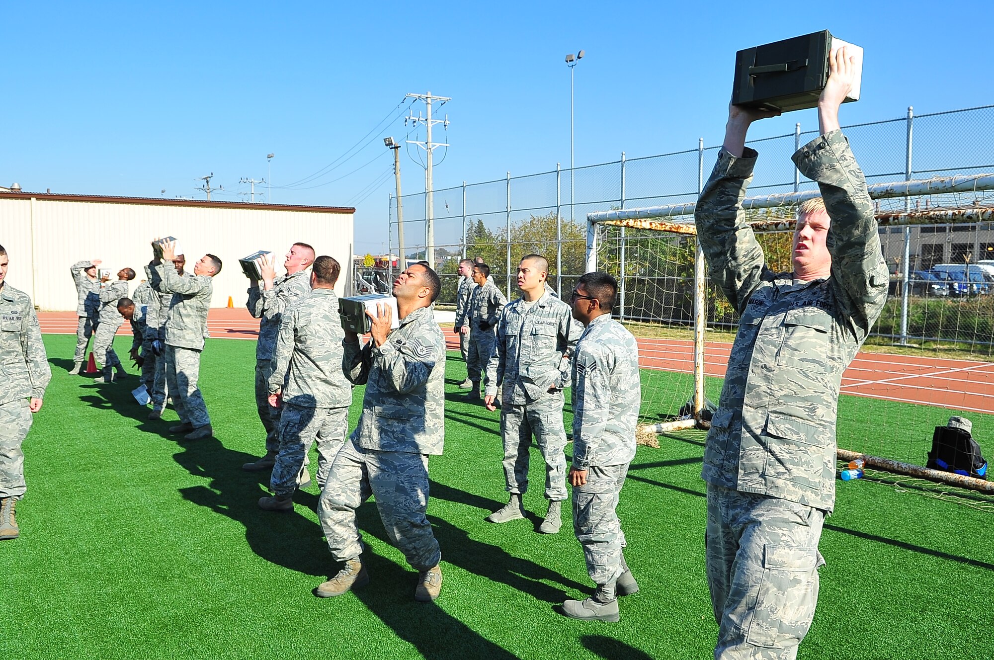 Airmen perform 30-pound ammo can lifts during the Combat Fitness Challenge Oct. 26, 2012. More than 86 Airmen challenged themselves to the Marine event to see where their abilities ranked against their sister service. (U.S. Air Force photo/Tech. Sgt. Raymond Mills)