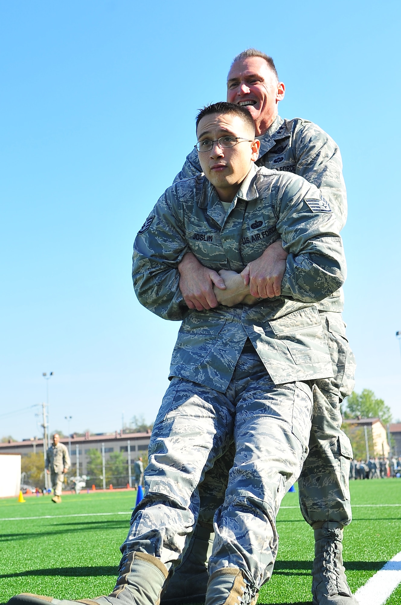 Maj. Gen. Kurt Neubauer, 7th Air Force vice commander, buddy drags Staff Sgt. Ryan Joslin, 7th Air Force command chief executive assistant, during the Combat Fitness Challenge, Oct. 26, 2012. Approximately 86 Airmen took the test consisting of a half a mile sprint in full uniform, a 30-pound ammo can lift, and maneuver under fire events combining a shuttle run, grenade throw, buddy carry, fireman’s carry, ammunition drag, sprints and low and high crawls. (U.S. Air Force photo/Tech. Sgt. Raymond Mills)