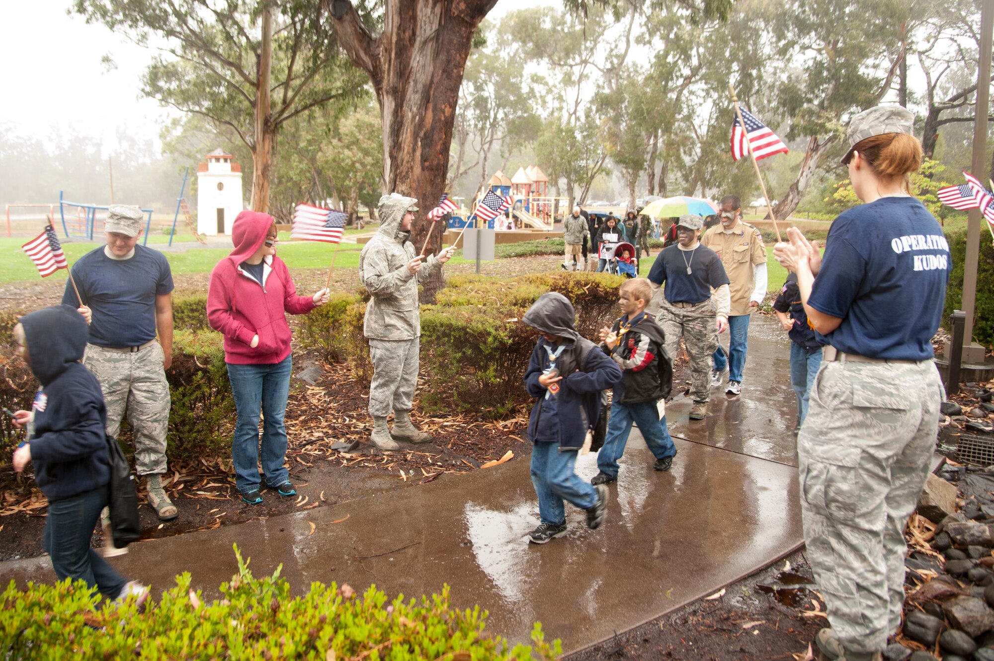 VANDENBERG AIR FORCE BASE, Calif. – Children participating in the Kids Understanding Deployment Operations event are welcomed back from their “deployment” with flag waving and cheers from the volunteers at Cocheo Park during this year’s event here Saturday, Nov. 17, 2012. KUDOS simulated a deployment processing line for dependents to help them understand the deployment process their parents or guardians go through before deployment. (U.S. Air Force photo/Senior Airman Lael Huss)