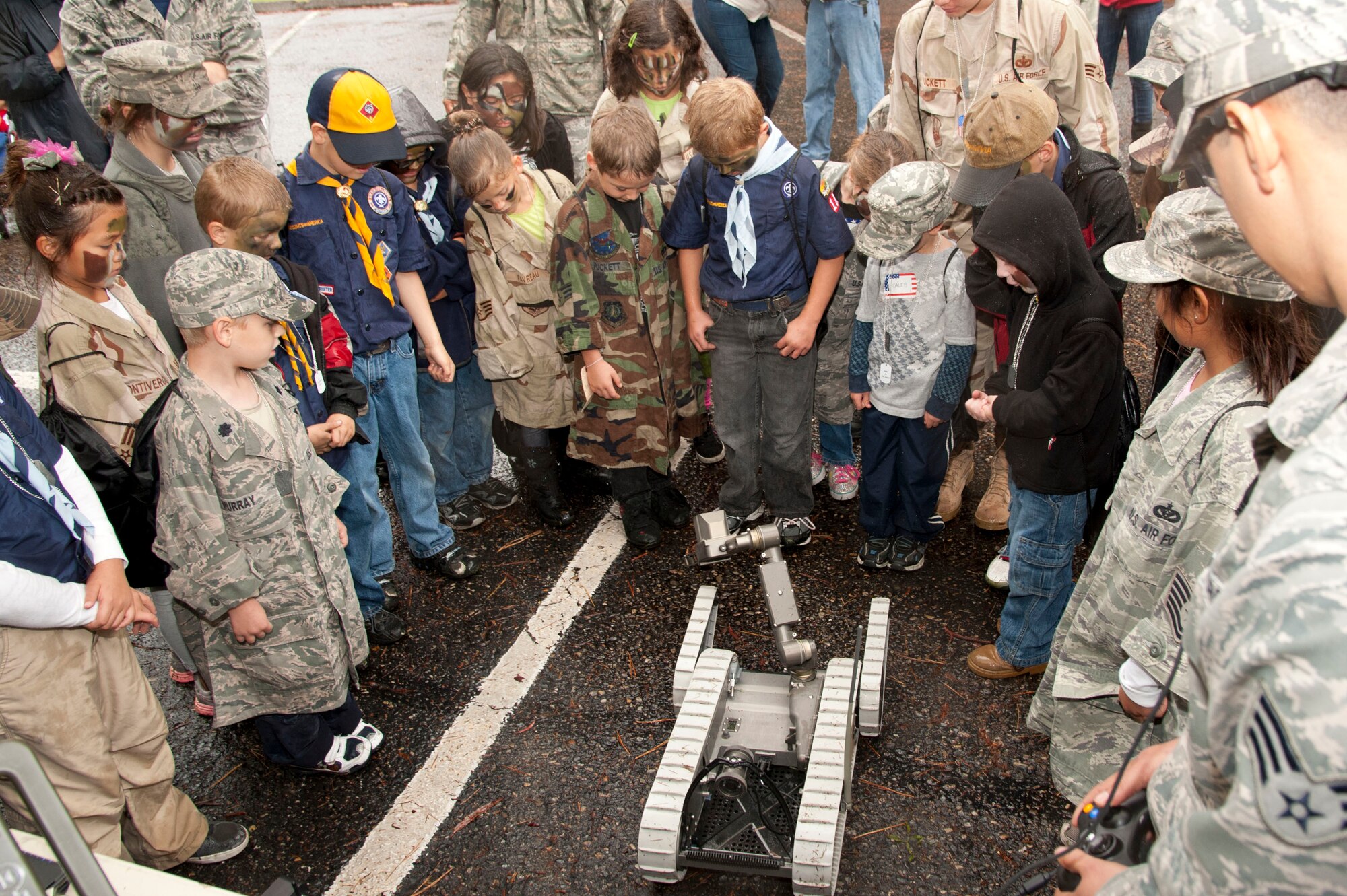 VANDENBERG AIR FORCE BASE, Calif. – Children attending the annual Kids Understanding Deployment Operations event gather around the Explosive Ordnance Disposal Flights’ portable robot at Cocheo Park here Saturday, Nov. 17, 2012. KUDOS simulated a deployment processing line for dependents to help them understand the deployment process their parents or guardians go through before deployment. (U.S. Air Force photo/Senior Airman Lael Huss) 
