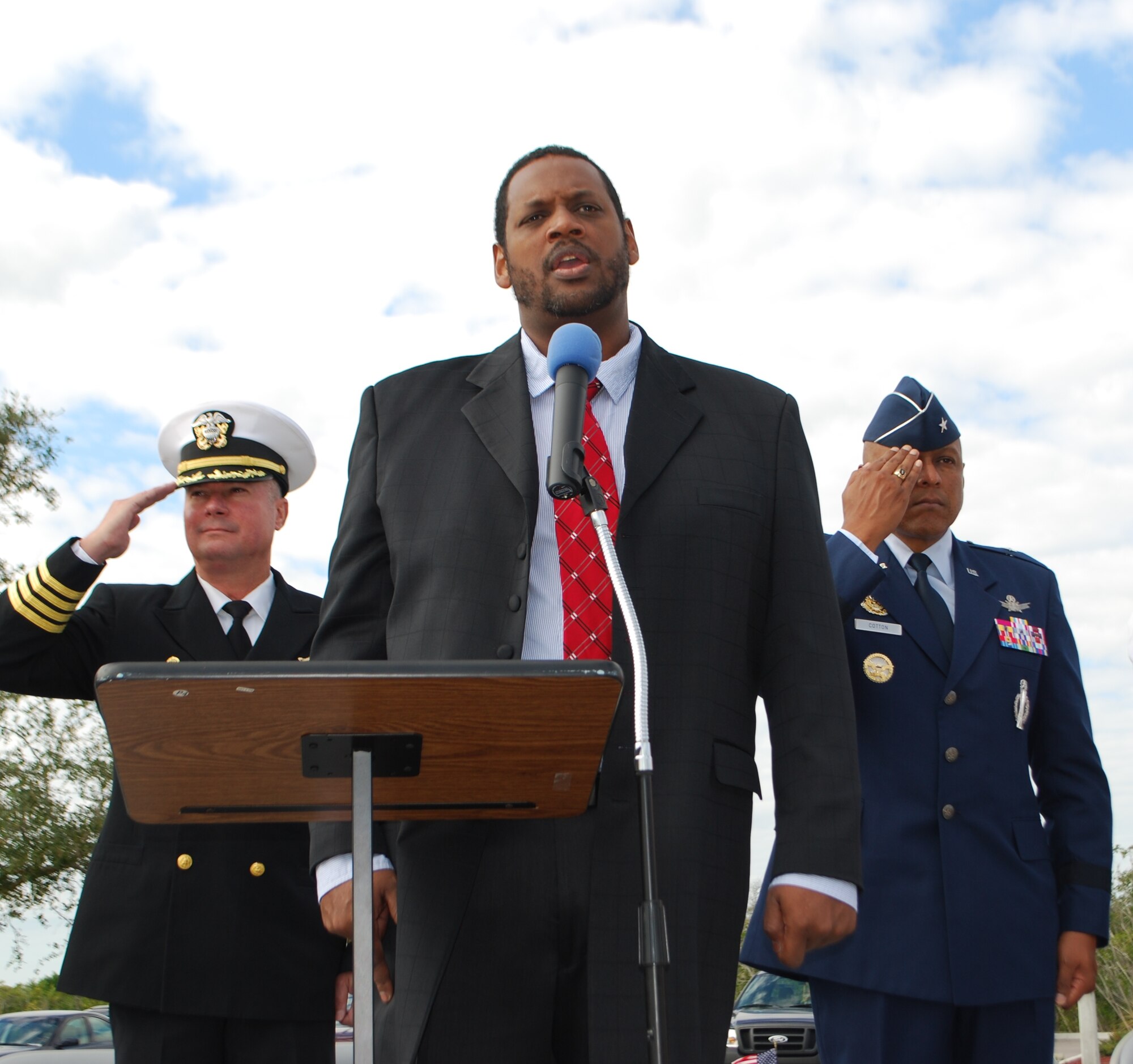 Phil Black, director of Music Ministry at Our Saviour's Catholic Church sings the National Anthem at the 2012 Veterans Day event held Nov. 10 at Brevard Veterans Memorial Center in Merritt Island. Rendering salutes are Brig. Gen. Anthony Cotton, right, commander, 45th Space Wing and Capt. J.P. Heatherington, commander, Naval Ordnance Test Unit. 

Photo by Chris Calkins