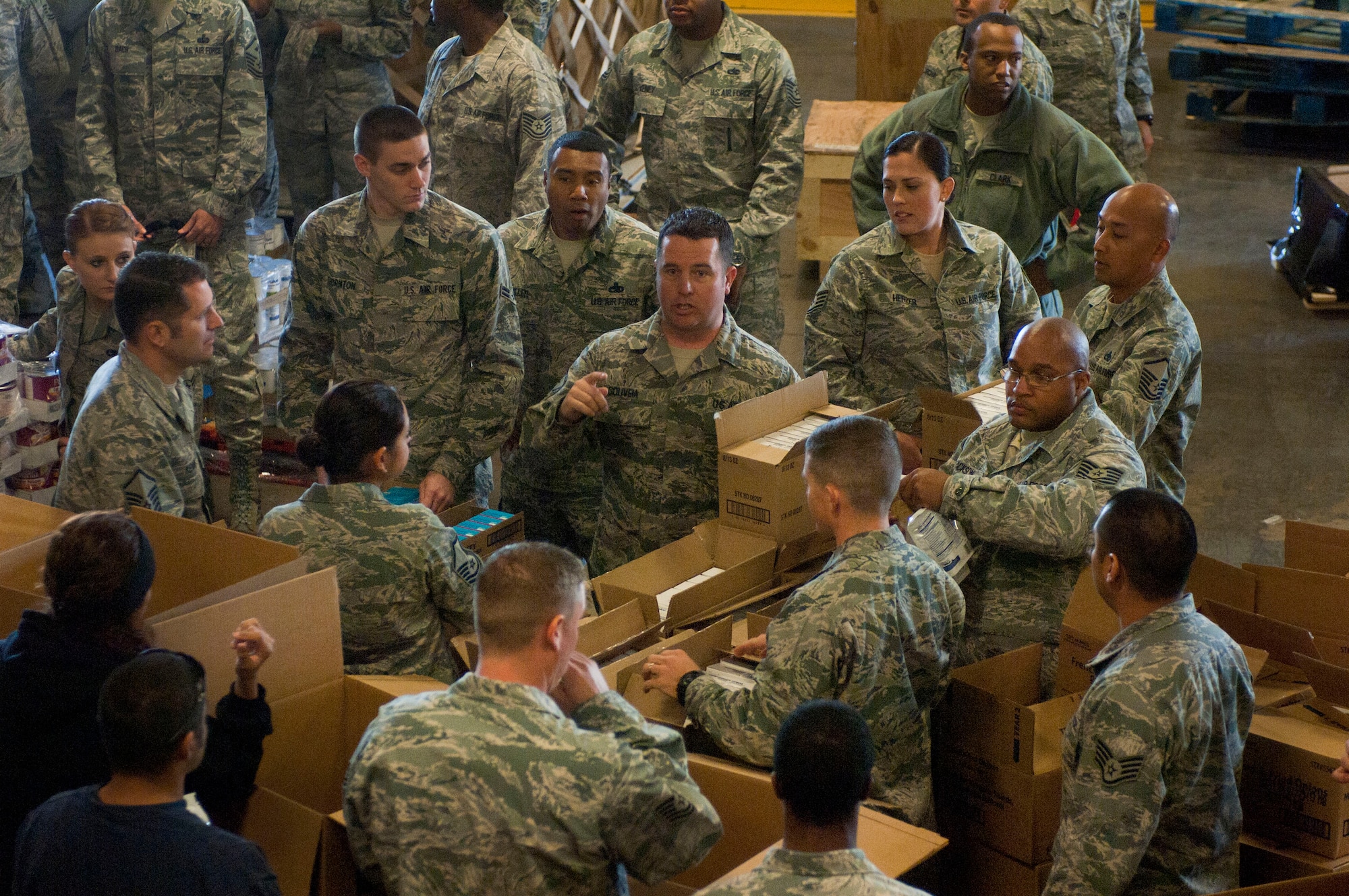 NELLIS AIR FORCE BASE, Nev.-- Master Sgt. Matthew Gouveia, U.S. Air Force Warfare Center first sergeant, directs volunteer Airmen helping with Operation Warm Heart, which donates Thanksgiving dinners to Nellis and Creech Air Force Base families, Nov. 13, 2012, at Nellis Air Force Base, Nev. Operation Warm Heart is funded by the Tug Boat association working with the First Sergeants Association. This year the operation donated 700 complete Thanksgiving meals. (U.S. Air Force photo by Senior Airman Jack Sanders)
