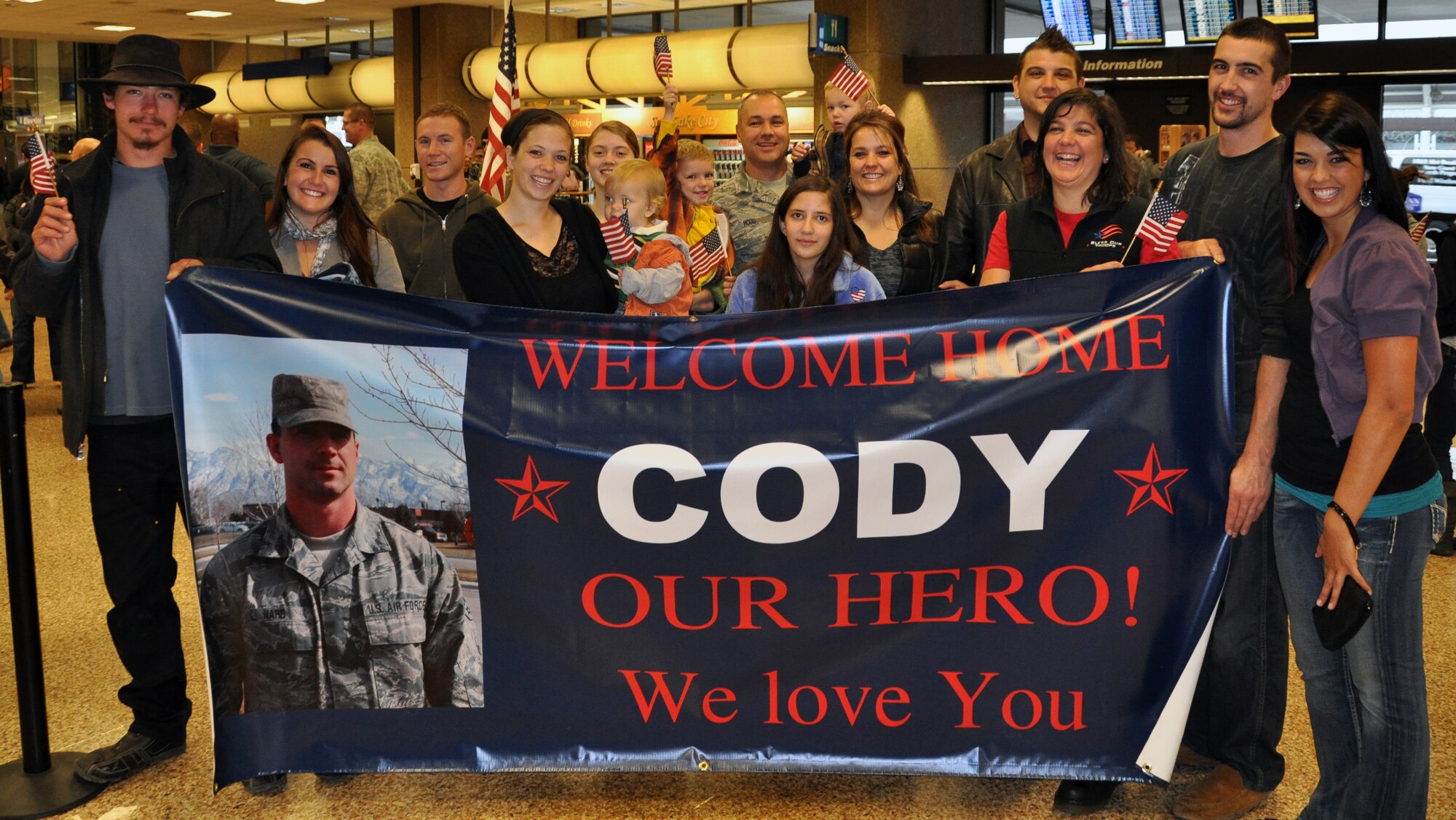 Family and friends waited to welcome home Senior Airman Cody Hard as he returned from deployment at the Salt Lake City International Airport, Nov. 16. Hard and eleven other members of the 130th Engineering Installation Squadron served a six-month deployment in support of Operation Enduring Freedom throughout several forward operating bases in Afghanistan. (U.S. Air Force photo courtesy Staff Sgt. Ashlee Hood)(RELEASED)