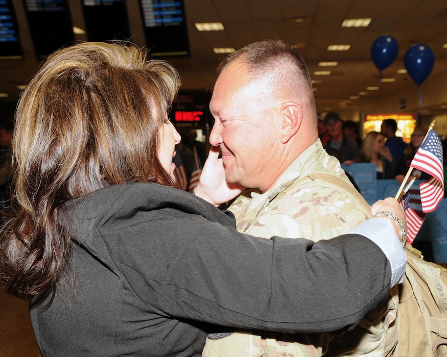Master Sgt. Vincent Tanner greeted his wife, Roshell, as he returned from deployment at the Salt Lake City International Airport, Nov. 16. Tanner and eleven other members of the 130th Engineering Installation Squadron served a six-month deployment in support of Operation Enduring Freedom throughout several forward operating bases in Afghanistan. (U.S. Air Force photo by Senior Airman Lillian Harnden)(RELEASED)