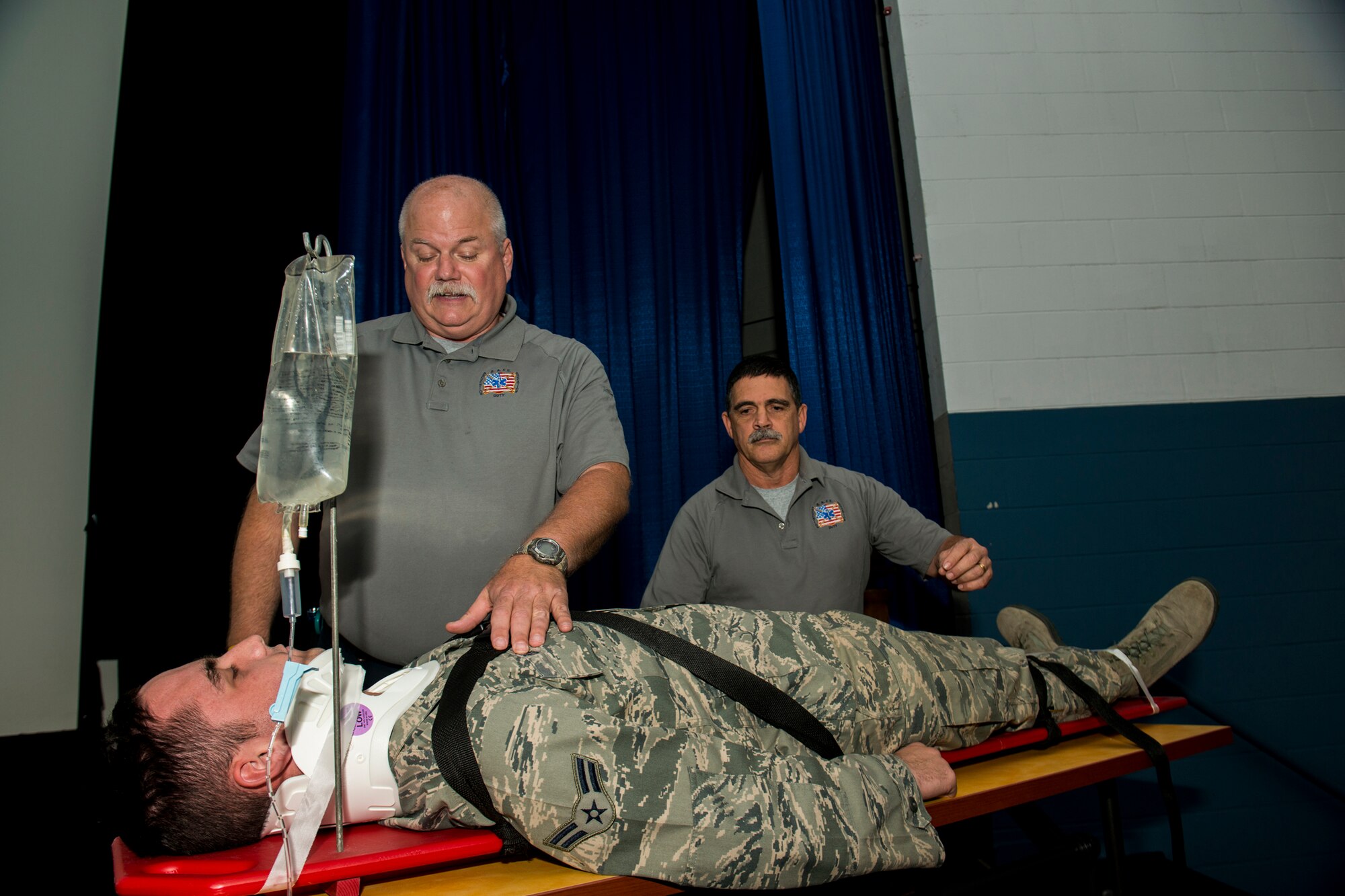 Greg McCarty and Ronny Garcia, Street Smart presenters, use the help of U.S. Air Force Airman 1st Class Anthony Diaz, 23d Logistics Readiness Squadron, to reenact medical procedures given to a traffic accident patient during a Street Smart safety presentation Nov. 16, 2012, at Moody Air Force Base, Ga. Street Smart began in 1988 in Miami and has since grown to be a worldwide saftey initiative. (U.S. Air Force photo by Staff Sgt. Jamal D. Sutter/Released) 