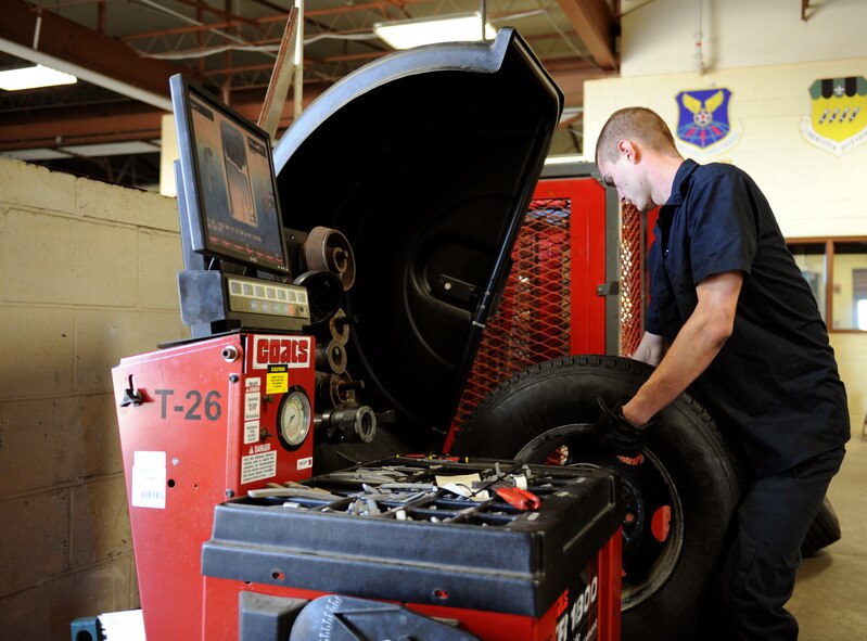 Airman 1st Class Kenneth Bates, 2nd Logistics Readiness Squadron Allied Trades section journeyman, places a tire on a tire balancer on Barksdale Air Force Base, La., Nov. 19. The balancer rotates the tire and checks to see if both sides are properly balanced. If not, the Airmen put weights on the tire to ensure proper balance. An unbalanced tire creates uncomfortable driving conditions including vibrations in the vehicle and difficulty steering. (U.S. Air Force photo/Airman 1st Class Benjamin Gonsier)(RELEASED)
