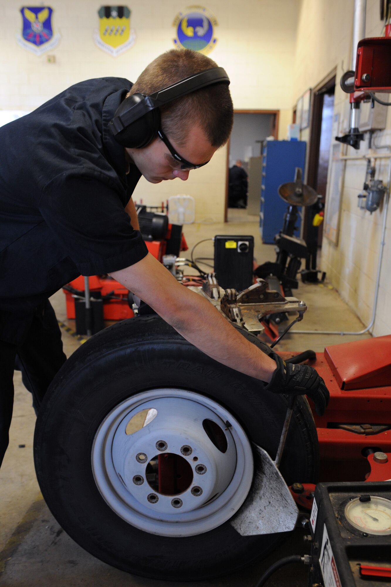 Airman 1st Class Kenneth Bates, 2nd Logistics Readiness Squadron Allied Trades section journeyman, removes a rim from a tire on Barksdale Air Force Base, La., Nov. 19. When a tire is worn out, it is demounted and replaced with a new one. The maintainers at the 2 LRS tire shop repair tires that contain nails, screws and bolts, broken valve stems, tires that have blown out from abnormal use, and wear and tear. They also perform more than 100 tire changes each month. (U.S. Air Force photo/Airman 1st Class Benjamin Gonsier)(RELEASED)
