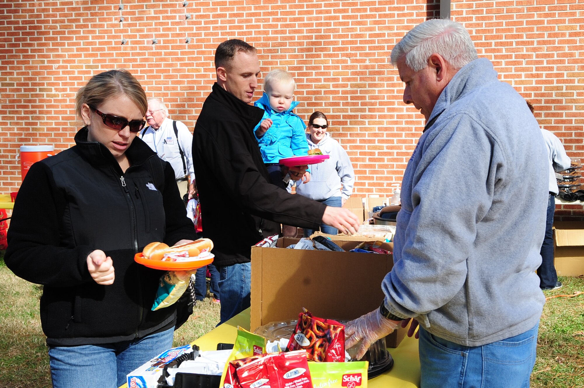 Members of Team Seymour grab food during the Month of the Military Family Block Party on Seymour Johnson Air Force Base, N.C., Nov. 17, 2012. The event was hosted by members of the 4th Force Support Squadron. (U.S. Air Force photo/Airman 1st Class Aubrey White/Released)