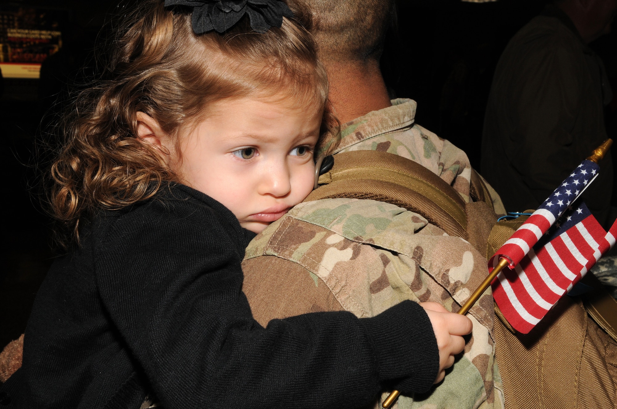 Senior Airman Dave Santistevan's young daughter embraced him after he returned from deployment at the Salt Lake City International Airport, Nov. 16. Santistevan and eleven other members of the 130th Engineering Installation Squadron served a six-month deployment in support of Operation Enduring Freedom throughout several forward operating bases in Afghanistan. (U.S. Air Force photo by Staff Sgt. Joe Davis)(RELEASED)