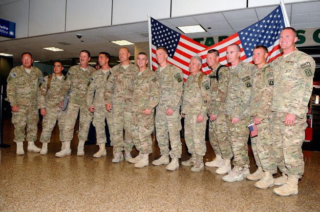 Twelve members of the 130th Engineering Installation Squadron posed for a group photo as they returned from deployment at the Salt Lake City International Airport, Nov. 16. The returning Guard members served a six-month deployment in support of Operation Enduring Freedom throughout several forward operating bases in Afghanistan. (U.S. Air Force photo by Senior Airman Lillian Harnden)(RELEASED)