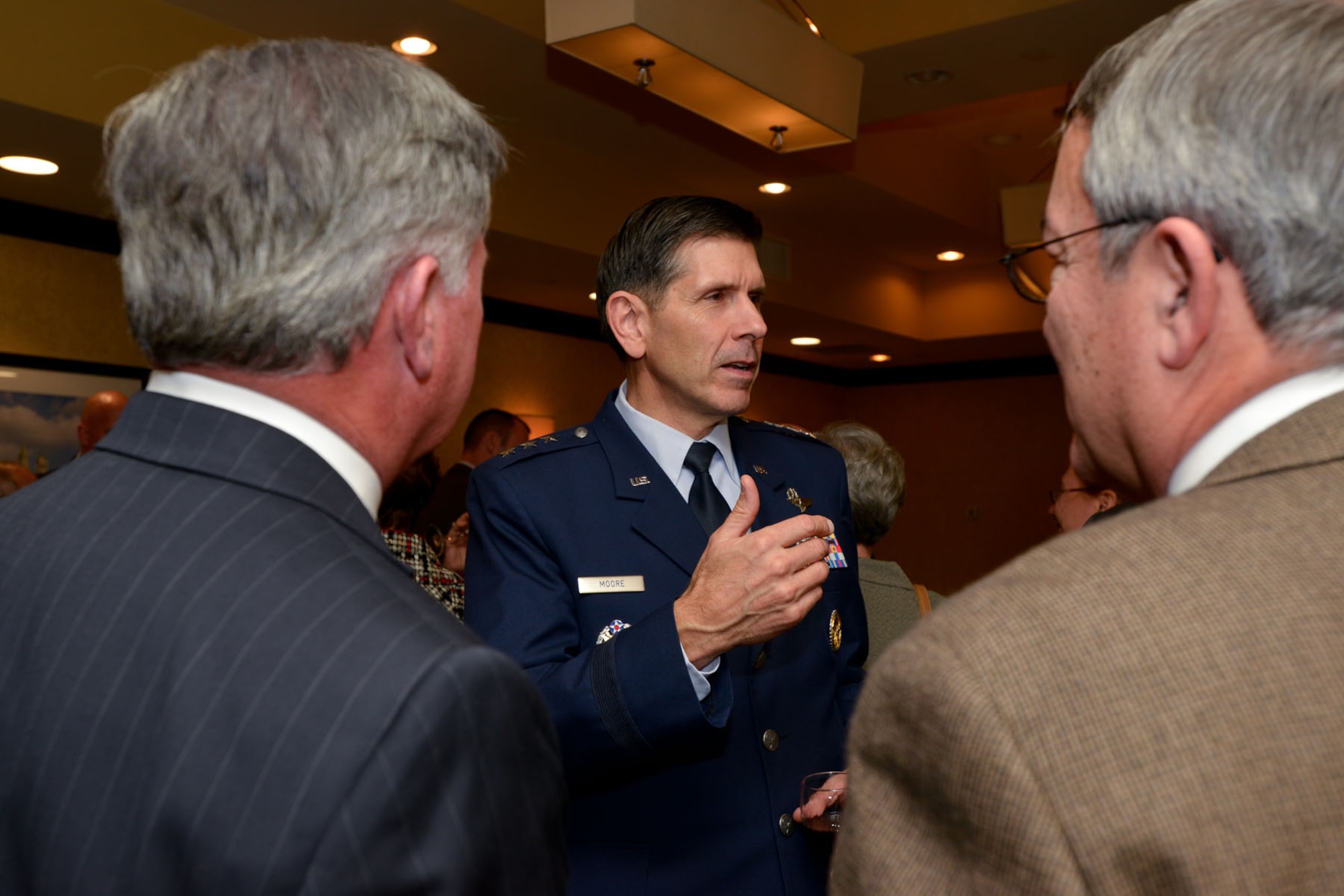 WOBURN, Mass. – Lt. Gen. C.D. Moore, Air Force Life Cycle Management Center commander, speaks to Randy Nunley of Odyssey Systems Consulting Group and Mark Klicker from P.E. Systems during a social before the North Suburban Chamber of Commerce dinner held at the Woburn Hilton Nov. 14. During the dinner, Moore presented information about AFLCMC and Hanscom’s vital role in national defense. (U.S. Air Force photo by Mark Herlihy)