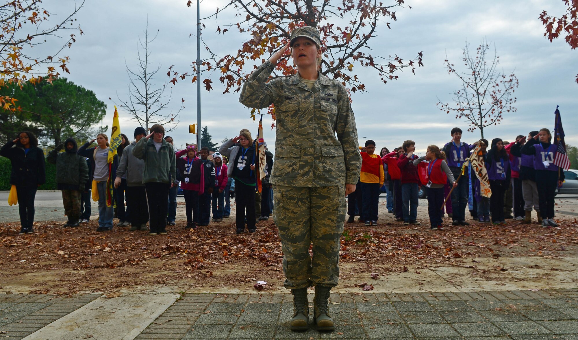 The simulated troops and SSgt. Amanda Arndt, 31st Civil Engineer Squadron co-lead coordinator for the deployment camp, practice saluting before the closing ceremony at Aviano Air Base, Italy, Nov. 18. The 2-day mock deployment camp hosted more than 40 children that learned a multiple of teachings such as marching, facing movements, and how to stand at the position of attention. (U.S. Air Force photo/Airman 1st Class Matthew Lotz)
