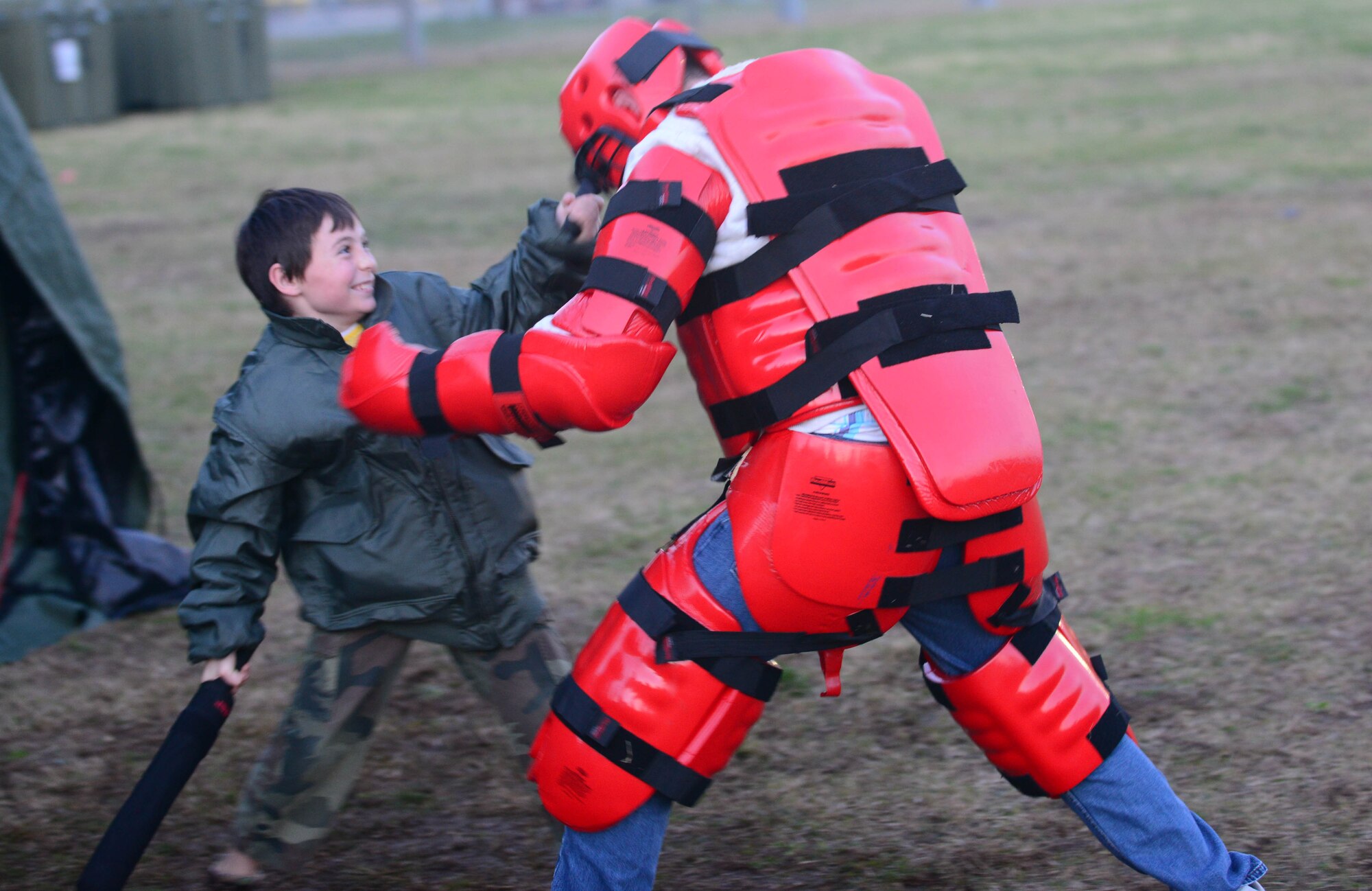 Jacob Lister, son of MSgt. Jason Lister, uses combatives to takedown a simulate enemy during the deployment camp at Aviano Air Base, Italy, Nov. 17. Several squadrons such as 31st Operations Support Squadron, 31st Civil Engineer Squadron, 31st Force Support Squadron, 31st Logistics Readiness Squadron, chapel and public health staffs and legal services helped volunteer with the deployment to give the children the feel of what their military family members go through during a deployment. (U.S. Air Force photo/Airman 1st Class Matthew Lotz) 