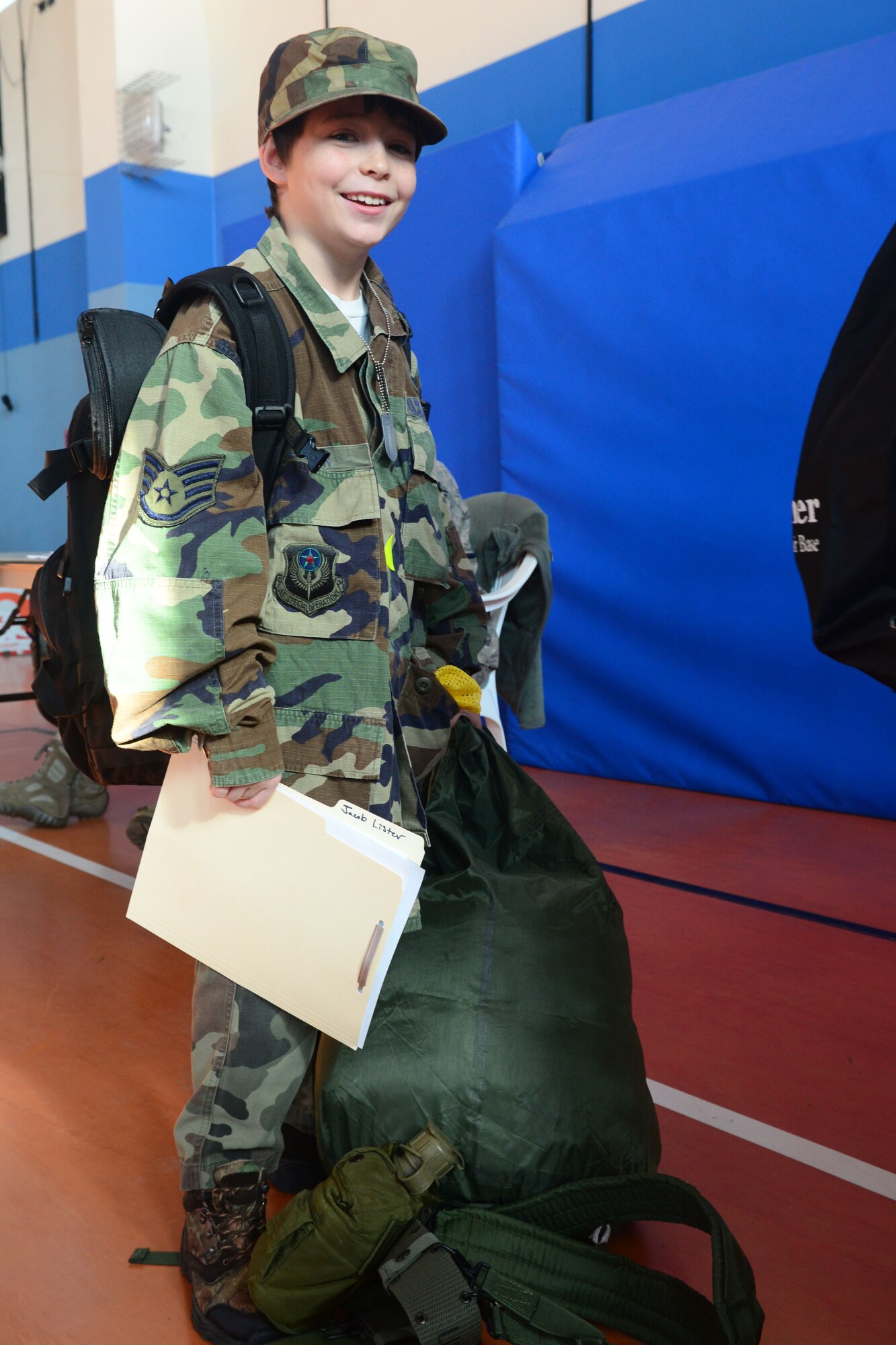 Jacob Lister, son of MSgt. Jason Lister, prepares his bags to load onto the bus during the deployment camp at Aviano Air Base, Italy, Nov. 17. The base hosted a 2-day mock deployment camp for a group of 9 to 15-year-old kids to give them the feel of what their military family members go through during a deployment. More than 40 children participated in several different events from learning how to march to completing an obstacle course. (U.S. Air Force photo/Airman 1st Class Matthew Lotz) 