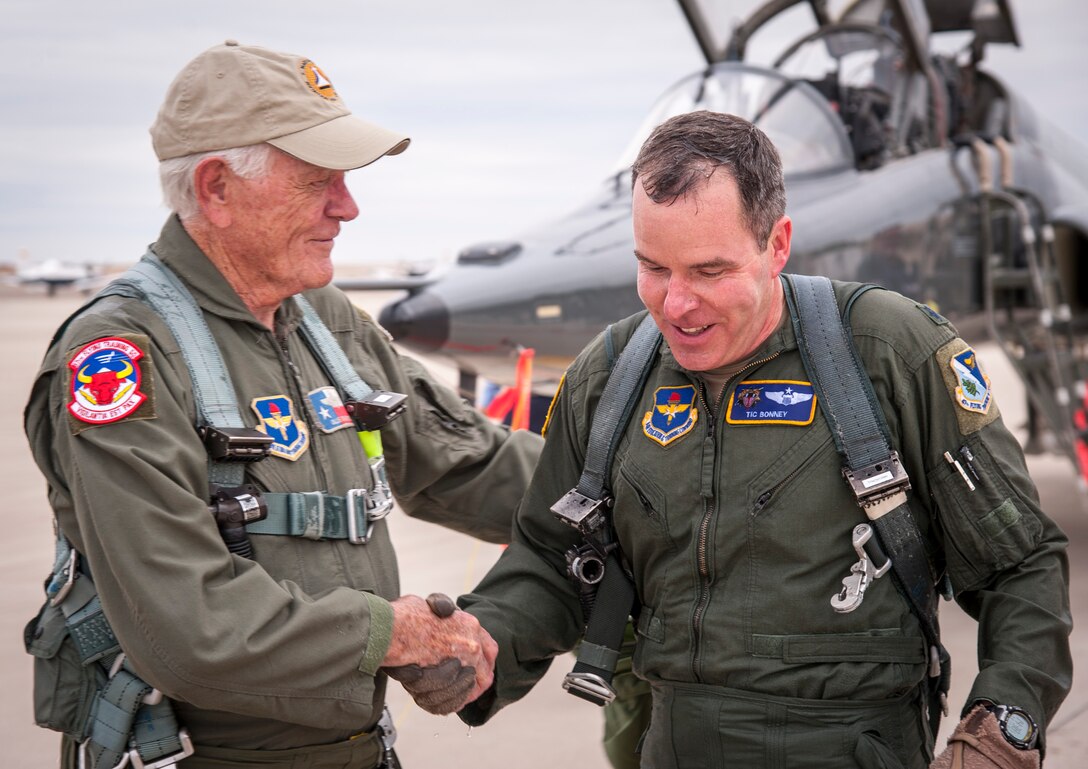 Oliver “Ollie” Crawford, an American airpower legend and his grandson Lt. Col. Oliver Bonney, 47th Operations Support Squadron director of operations, greet each other after Bonney’s final flight at Laughlin Air Force Base, Texas, Nov. 16, 2012. Crawford was invited to speak with Laughlin’s latest class of graduating pilots and then flew with the 87th Flying Training Squadron in a T-38. (U.S. Air Force photo/Airman 1st Class Nathan Maysonet)  