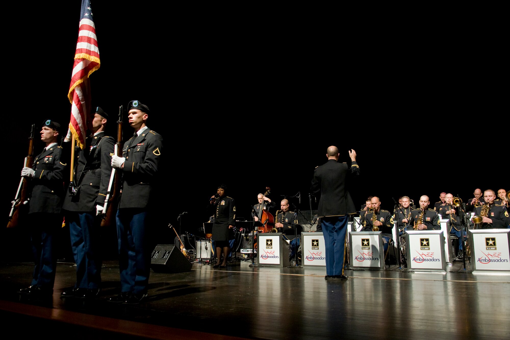 GRISSOM AIR RESERVE BASE, Ind. -- From left, U.S. Army Pfc. Michael Klingsmith, Spc. Fayne Lawson and Pfc. Alexander Woodall present the Colors as Master Sgt. Marva Lewis and the U.S. Army Field Band's Jazz Ambassadors perform the national anthem at the start of a special Veterans Day concert at the Honeywell Center in nearby Wabash, Ind., Nov. 12. The three color guardsmen are assigned the U.S. Army Reserve's 316th Tactical Psychological Operations Company at Grissom. (U.S. Air Force photo/Tech. Sgt. Mark R. W. Orders-Woempner)
