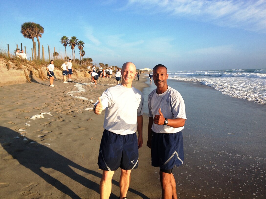 Col. Robert Pavelko, vice commander, 45th Space Wing, and Chief Master Sgt.
Herman Moyer, wing command chief, give a "thumbs up" to doing the Wing
Warrior Run on the beach.

Photo courtesy of 45th Force Support Squadron
