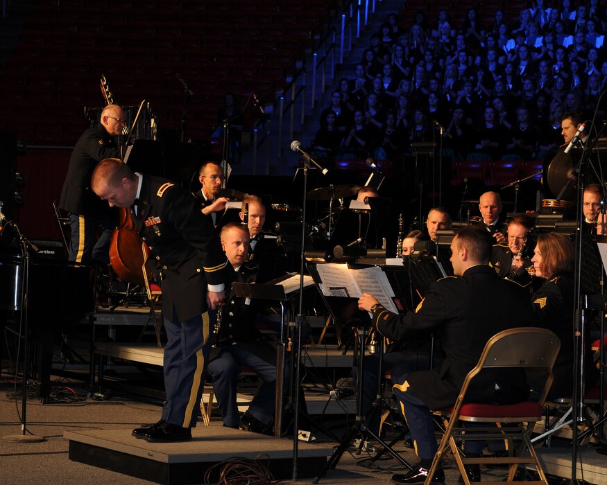 Chief Warrant Officer 2 Denny Saunders takes a bow after conducting the opening number, "The Footlifter," during the Utah National Guard's 57th annual Veterans Day concert at the University of Utah's Jon M. Huntsman Center, Nov. 10. Saunders led the Utah National Guard's 23rd Army Band and a 600-voice combined choir from Granite School District high schools through several numbers during the evening event. (U.S. Air Force photo by Senior Airman Lillian Harnden)(RELEASED)
