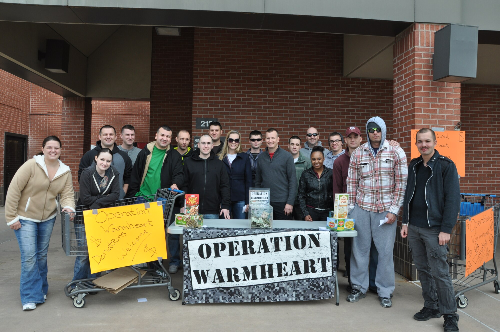 GOODFELLOW AIR FORCE BASE, Texas- Volunteers for Operation Warmheart gather for a group photo outside the base commissary here Nov. 17. The volunteers assisted the First Sergeant Council with Operation Warmheart in collecting approximately  $800  and  one thousand pounds of food that will be given to military and civilian families in need on Goodfellow during the Thanksgiving holiday. (U.S. Air Force photo/ Airman 1st Class Erica Rodriguez)