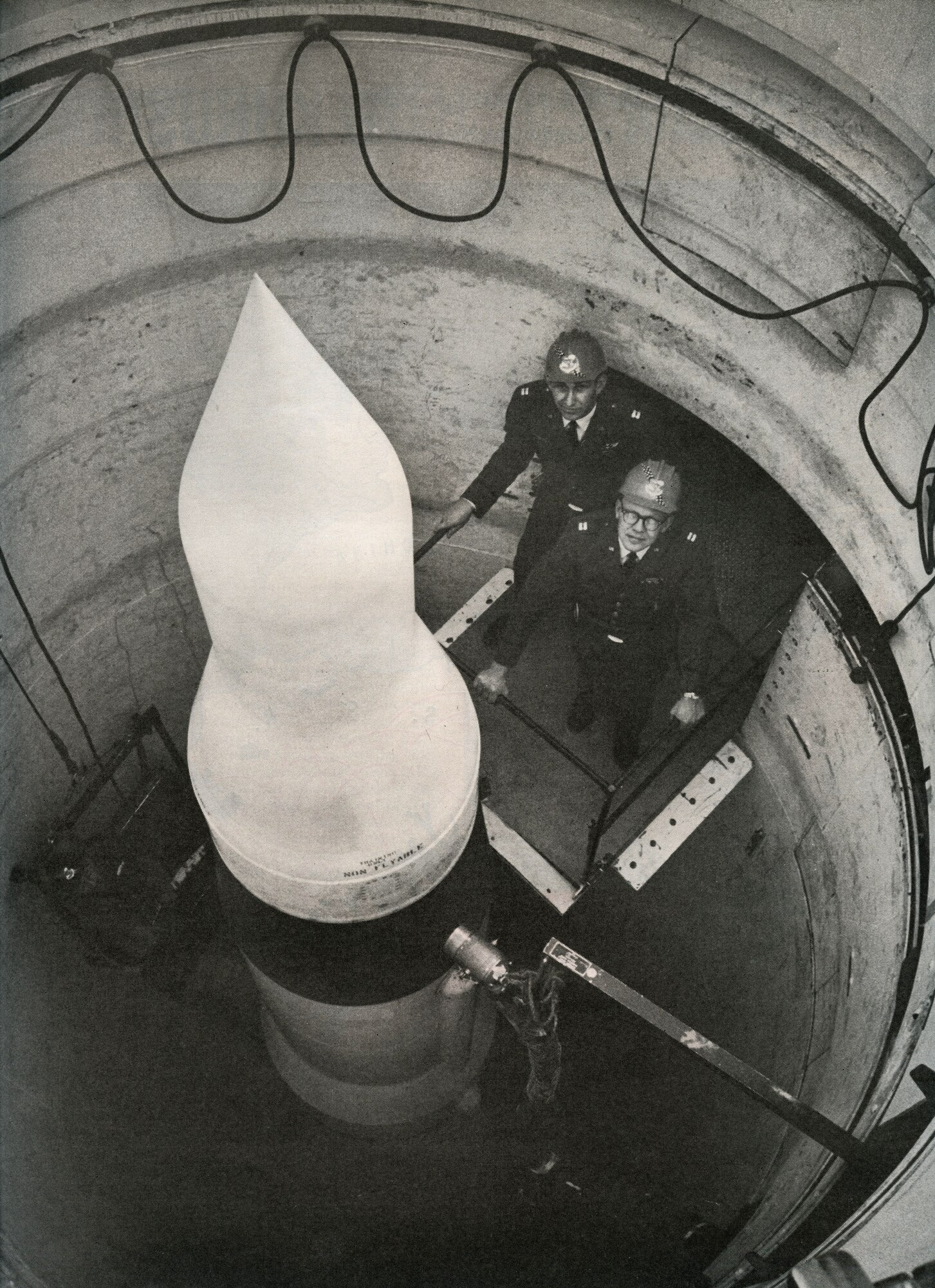 MISSILE COMPLEX, S.D. -- Captains Allen Lamb and Bill Christians, missile combat crew commanders, stand on a platform at a missile silo, November 1964. This year marks the 50th Anniversary of the installation of the first Minuteman Intercontinental Ballistic Missile. As these photos show, the mission has existed for decades and will continue to provide safe, secure and effective strategic deterrence for years to come. (LIFE photo/Bill Ray)