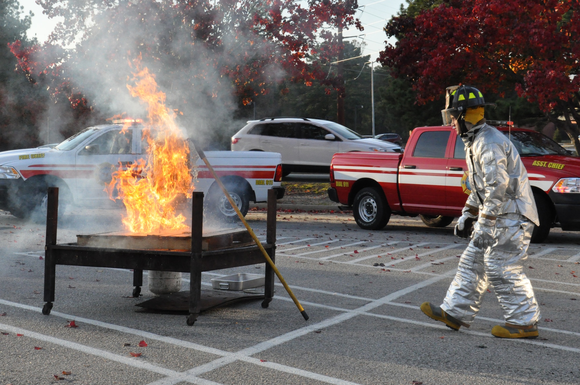 U.S. Air Force Senior Airman Daniel Gough, 4th Civil Engineer Squadron fire fighter, backs away from a deep fryer after dropping in a frozen turkey during a Turkey Fryer Fire demonstration on Seymour Johnson Air Force Base, N.C., Nov. 16, 2012. Flames engulfed the pot and supporting structure in less than five seconds, representing the outcome of frying an unthawed turkey. (U.S. Air Force photo/Airman 1st Class Mariah Tolbert/Released)