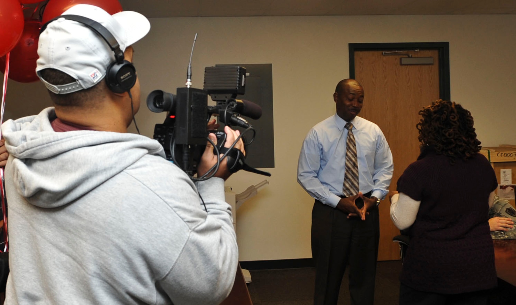 Rhonda Arrington, Fox 43's "Face of Fox" reporter, presents Robert Canada, a detective with the 733rd Security Forces Squadron, the station's Hampton Roads Hero Award at the squadron's headquarters at Fort Eustis, Va., Nov. 19, 2012. Canada was nominated for the award by Madeline Peters after working with her son Jorge to improve his attitude and keep him out of trouble. (U.S. Air Force photo by Staff Sgt. Wesley Farnsworth/Released)