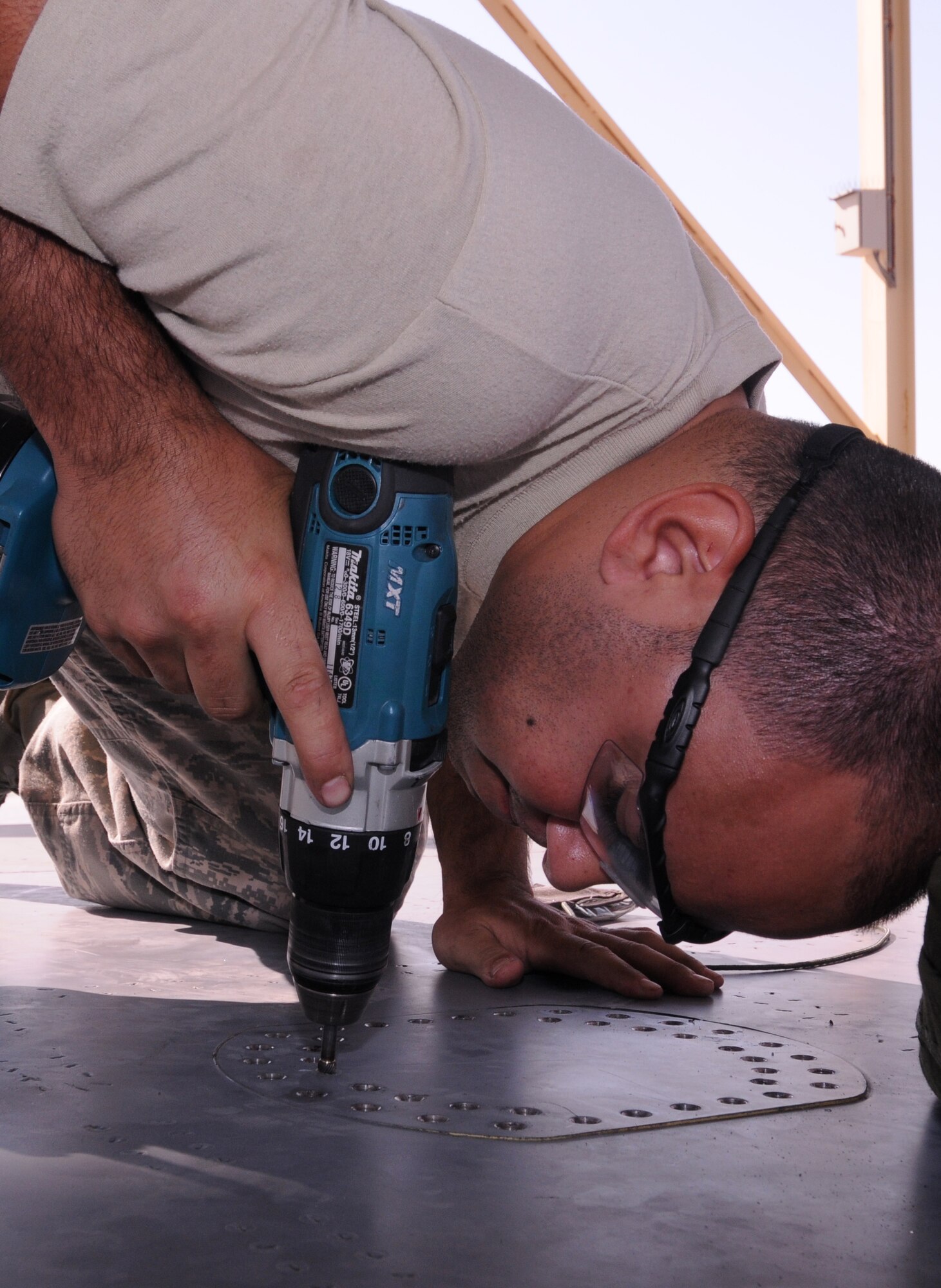 SOUTHWEST ASIA -- U.S. Air Force Staff Sgt. Thomas Gonzalez, 380th Expeditionary Maintenance Squadron fabrication flight aircraft structural maintenance technician, removes hardware from an aircraft wing panel Nov. 19, 2012. Gonzalez, a Fall River, Mass., native, is deployed from Kadena Air Base, Japan. (U.S. Air Force photo/Tech. Sgt. Amanda Savannah)